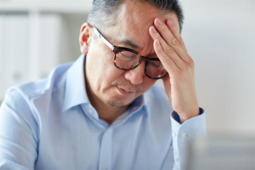 Man suffering from severe headache or migraine